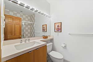 Bathroom featuring vanity and a stall shower
