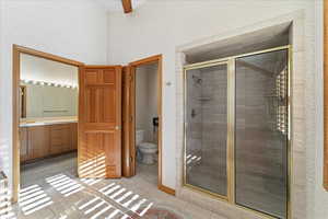Full bath with a shower stall, vanity, and light tile patterned floors