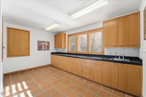 Kitchen with dark countertops and light tile patterned floors
