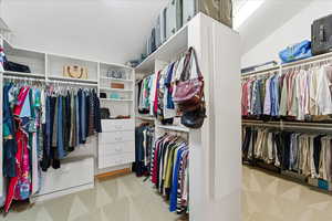Walk in closet with light carpet