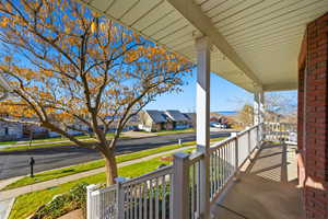 Covered Open Wrap-A-Round Porch with a residential view