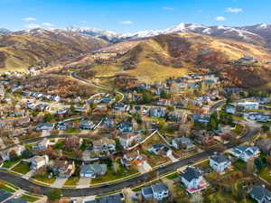 Aerial view of property's location featuring nearby suburban area and a mountainous background