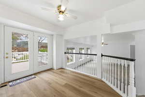 Kitchen dining area, door to newer trex deck, ceiling fan, ornamental molding, and wood finished floors