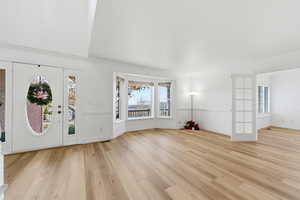 Foyer featuring light wood finished floors and baseboards