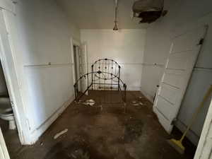 Spare room with unfinished concrete flooring