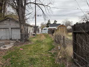 View of yard featuring a storage unit and a garage
