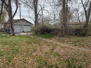 View of yard with an outbuilding and a garage