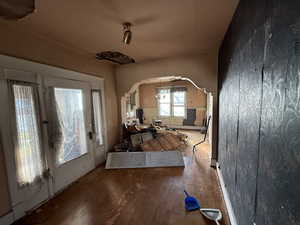 Foyer featuring hardwood / wood-style floors and arched walkways