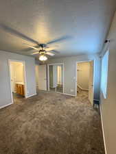 Primary bedroom view 3. Showing walk in closet, mirrored closet and bathroom entry.