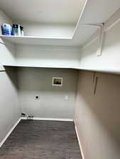 Laundry area with washer gas and electric hookups and shelving.