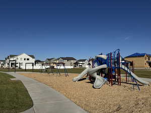 Community play area featuring a residential view and a lawn