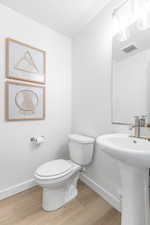 Bathroom with baseboards and light wood-style floors