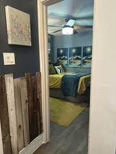 Bedroom featuring wood finished floors, ceiling fan, and a closet