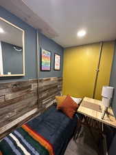 Bedroom featuring recessed lighting and wooden walls