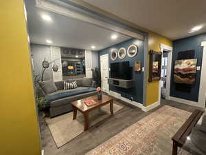 Living room with wood finished floors and recessed lighting