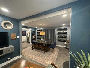 Dining room with wood finished floors and recessed lighting