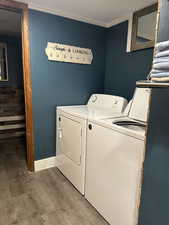 Laundry area featuring light wood finished floors and washing machine and dryer