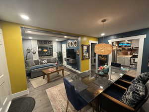 Living area with dark wood-style flooring and recessed lighting