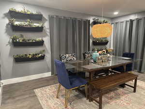 Dining area featuring wood finished floors and baseboards