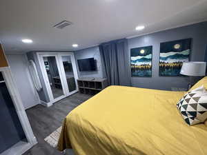 Bedroom with access to exterior, recessed lighting, and dark wood finished floors