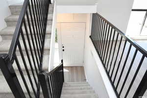 Stairs featuring wood finished floors