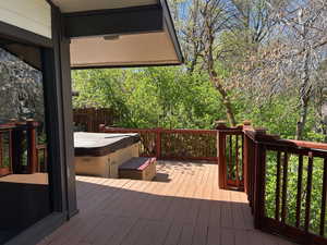 Wooden deck featuring a hot tub