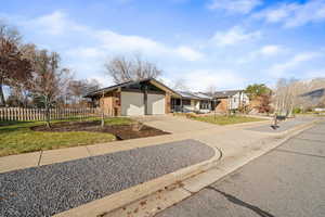 View of front of house featuring concrete driveway and a garage