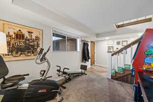 Workout room with light colored carpet