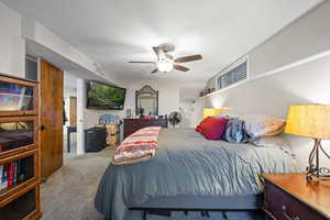 Carpeted bedroom with ceiling fan