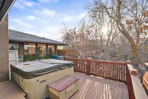 Wooden terrace featuring a hot tub