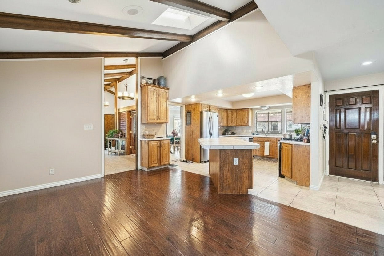 Kitchen with wood-finish cabinetry, white tile flooring, and a central island with a tile countertop