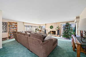 Living area featuring a fireplace and carpet floors