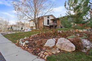 View of front of house with a residential view and a balcony