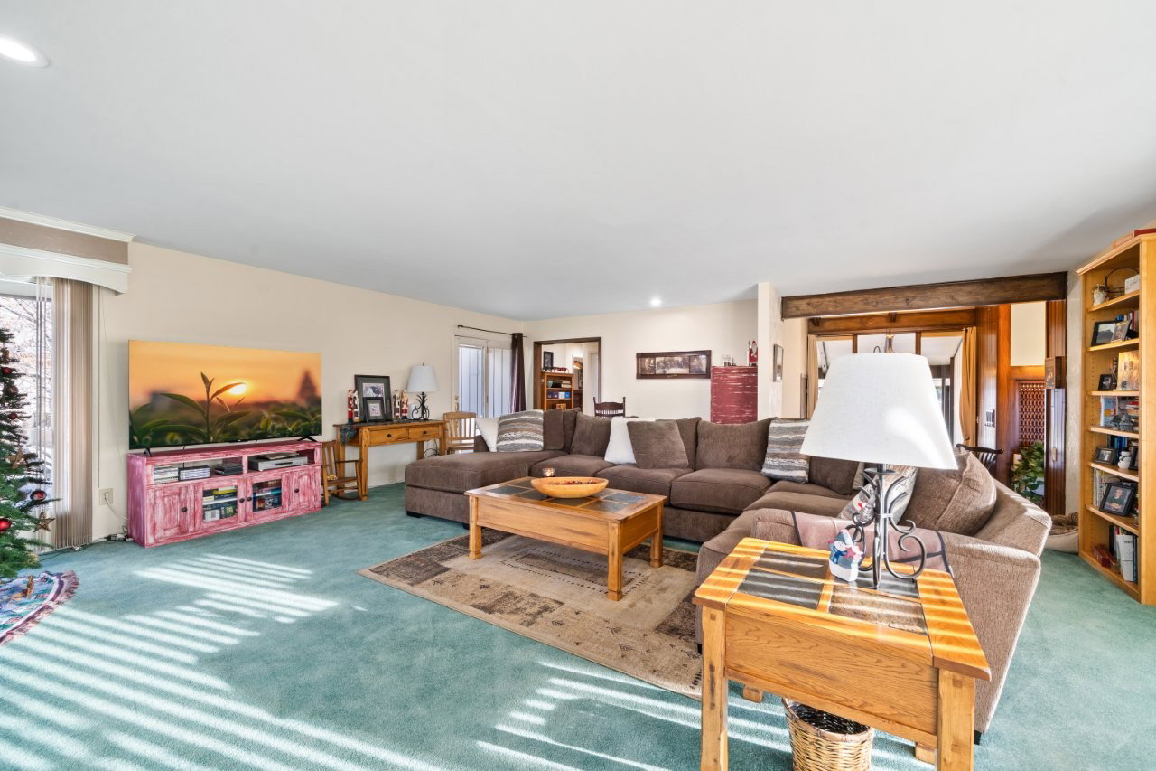Carpeted living room with recessed lighting