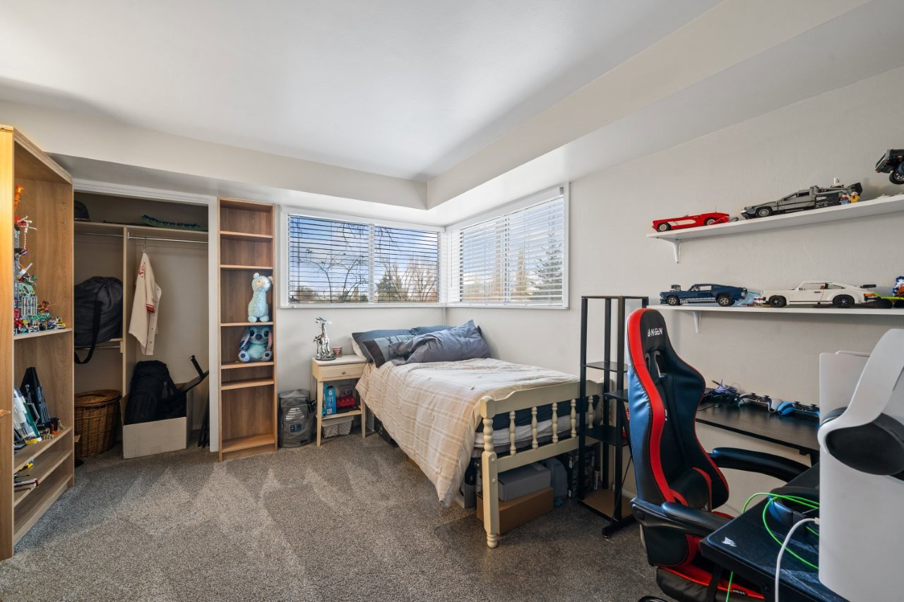 Bedroom featuring dark colored carpet and a closet