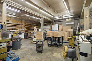 Miscellaneous room with a workshop area and a wall mounted air conditioner