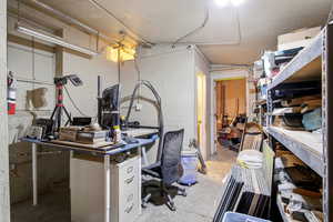 Home office featuring concrete floors