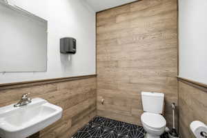 Bathroom featuring wooden walls and wainscoting