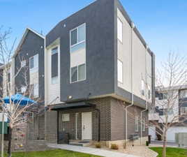 Front of house featuring stucco siding and brick siding