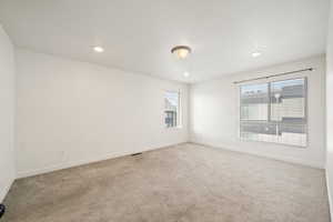 Unfurnished room featuring light carpet and recessed lighting