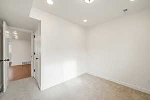 Spare room with carpet and recessed lighting