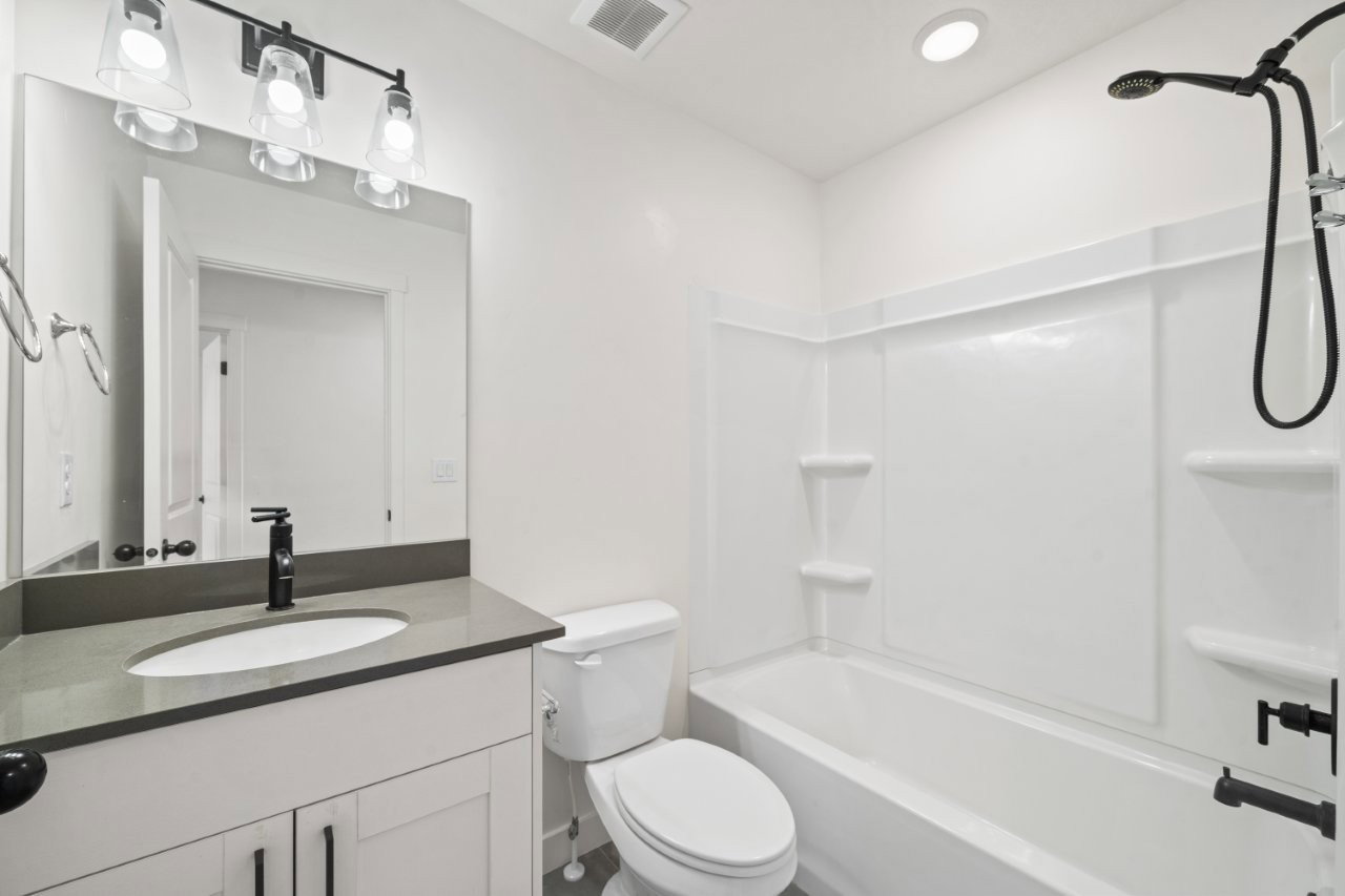 Bathroom with shower / bath combination and vanity