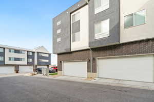 View of back of home featuring stucco siding and a two car garage