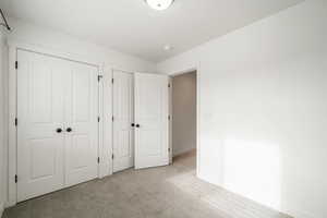 Unfurnished bedroom with carpet floors and a closet