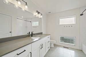Full bathroom featuring vanity, bathing tub / shower combination, and light tile patterned floors