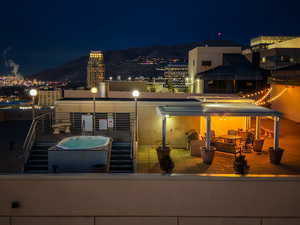 Exterior space featuring a patio area and a view of city lights