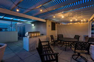View of patio / terrace featuring outdoor dining space, exterior kitchen, and a pergola