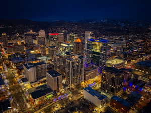 View of city featuring a view of city lights and a mountain backdrop