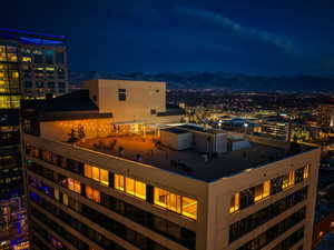 City view featuring a view of city lights and a mountain backdrop