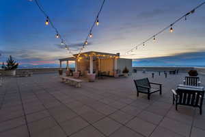 Patio terrace at dusk with a patio area and a mountain view